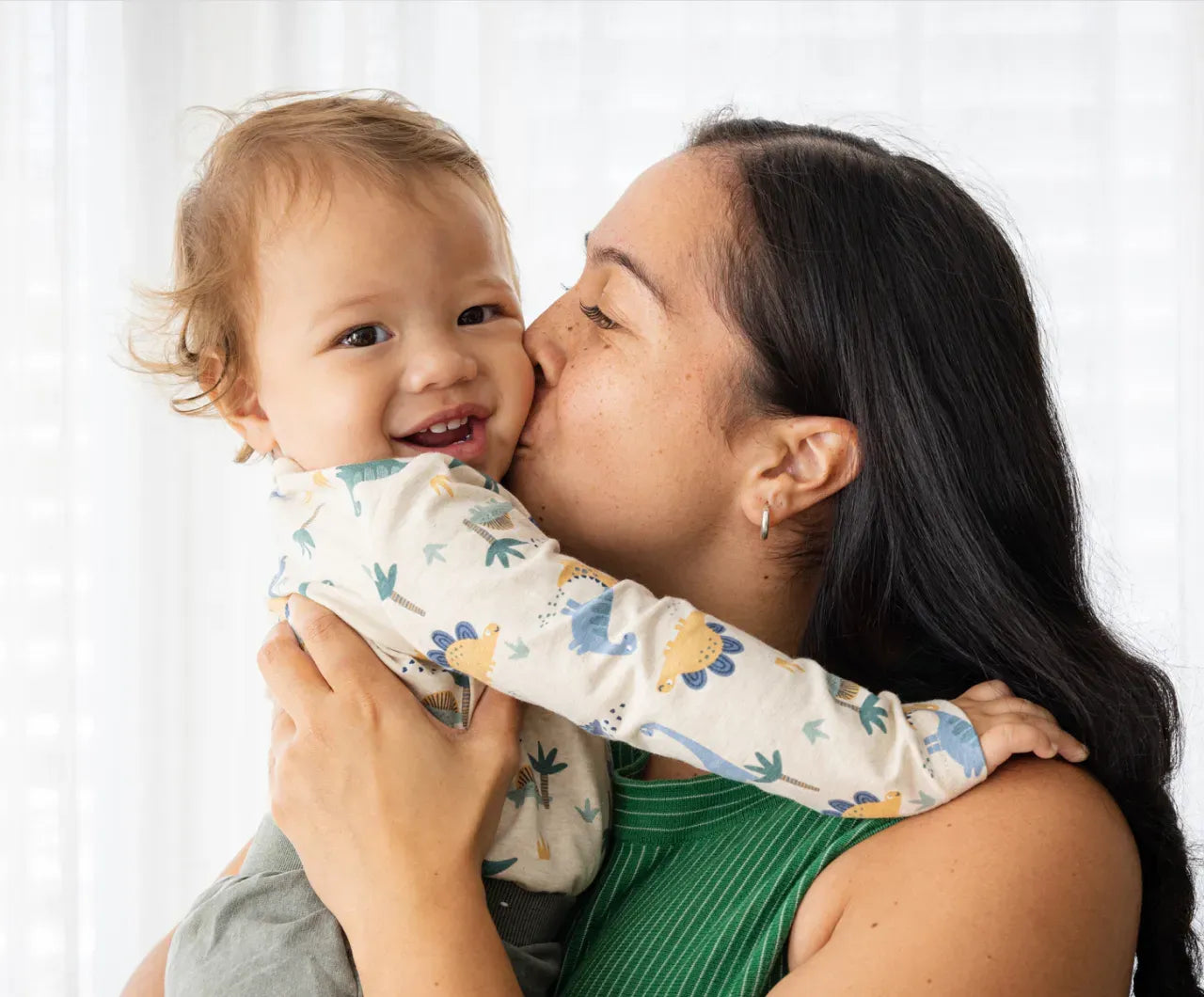 Mom kissing her baby on the cheek