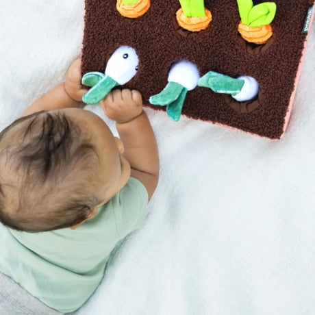 Baby playing with the Boppy Learn & Grow Sensory Toy